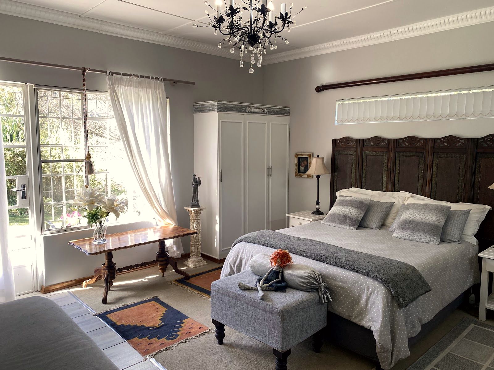 A bedroom with a chandelier